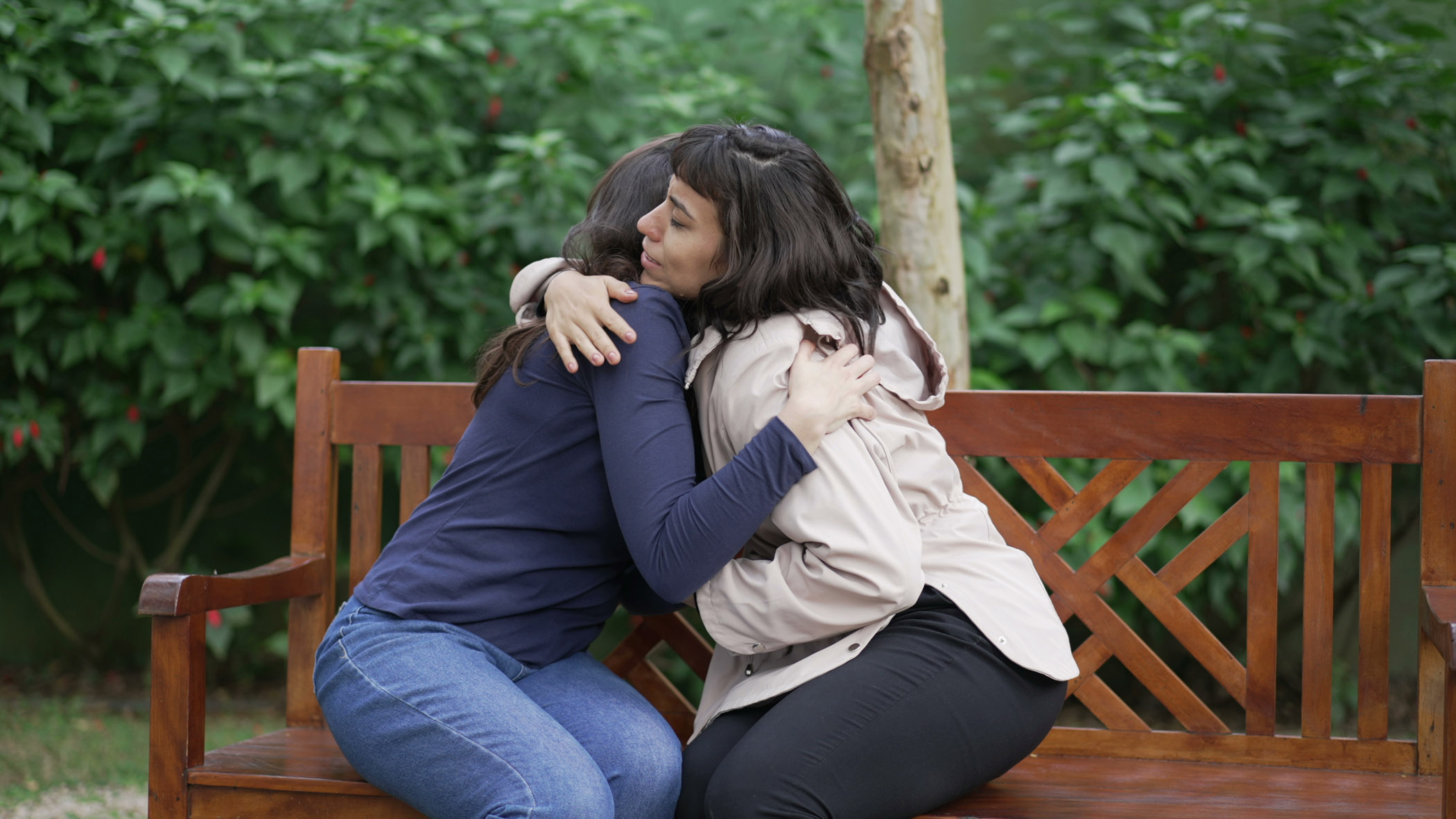 Sympathetic female friend in SUPPORT with suffering woman. Person in sorrow embracing supportive companion